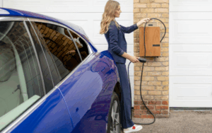 Woman charging electric vehicle